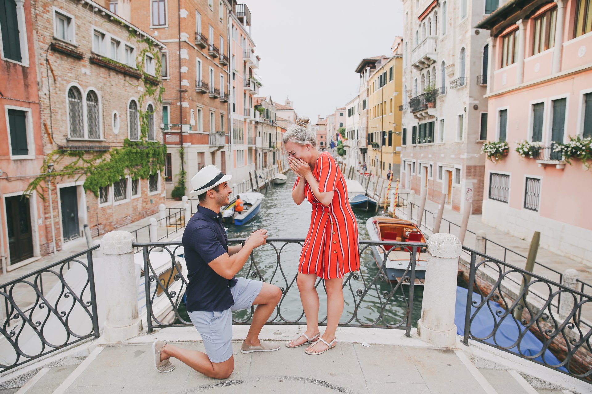 A proposal moment on a bridge overlooking a Venice canal